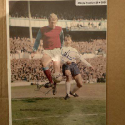Bobby Moore West Ham + Jimmy Greaves Tottenham Signed Picture: Stunning colour full size magazine picture with clear genuine undedicated autographs in biro of the both.