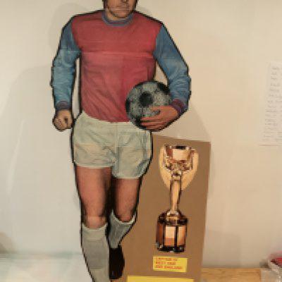 Bobby Moore Magazine Promotion Large West Ham Figure: 42 inch high cardboard cut out of Moore in West Ham kit used to promote a magazine in the late 60s. Has Jules Rimet trophy and his name. Rare item.