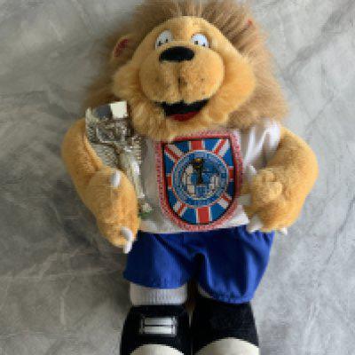 1966 World Cup Willie With Jules Rimet Trophy: Stunning lion with 1966 World Cup logo to chest holding the trophy. Very good condition 12 inch lion with tail we believe is not originally from the period.