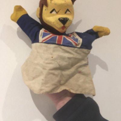 1966 World Cup Willie Rare Football Puppet: Possibly one of the rarest WC Willie items. Hand puppet featuring an England flag to his chest with copyright FA 1966 Made in England to edges. Wear and small hole to cloth.
