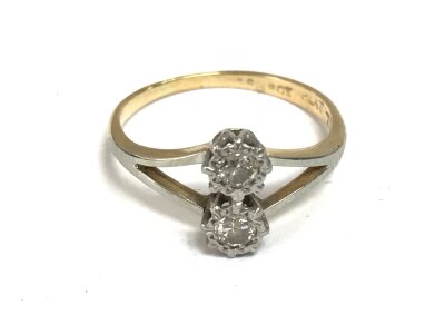 An 18ct gold and platinum ring set with two small diamonds. 2.14g and size K 1/2
