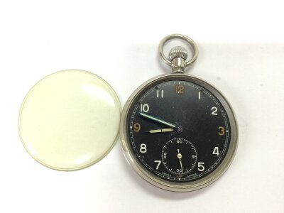 A military button wind pocket watch. Winds and seen running. Approximately 50mm case. NO RESERVE