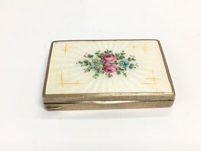 A vintage Austrian white metal compact with enamel floral spray decoration. NO RESERVE