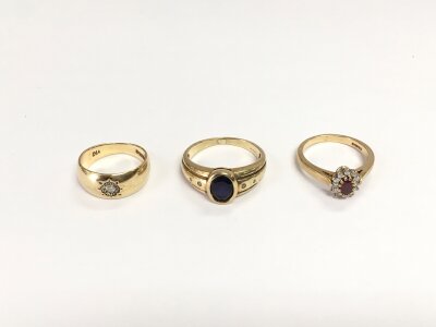 Three 9ct gold and stone set rings, total approx weight 9.4g.