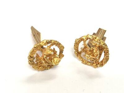 A pair of 10k gold cufflinks in the form of a prospector panning for gold, total approx weight