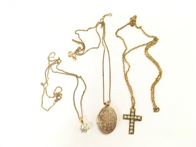 Three gold pendants on chains comprising a pearl encrusted cross, locket etc. Approx total weight 13.3g.
