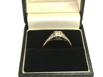 An Edwardian unmarked yellow metal ring set with stones, approx size S.