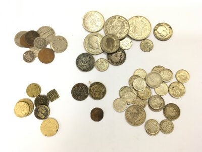 A collection of coins including silver examples,  an Irish penny, wedding token etc.