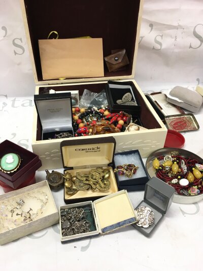 A box of costume jewellery including brooches, necklaces, cap badges etc
