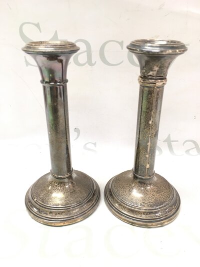 A pair of damaged candle sticks with silver hallmarked bases, 570g total weight. 18.5cm tall
