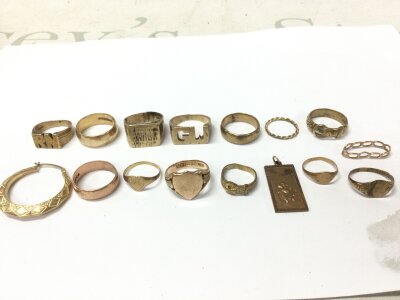 A collection of 9ct gold rings, an earring and a pendant. 64g