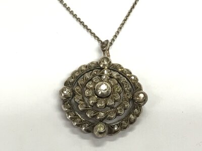 A diamond set pendant on a silver chain. Centre stone is approx 3mm