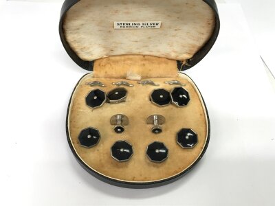 A cased set of silver studs in case.