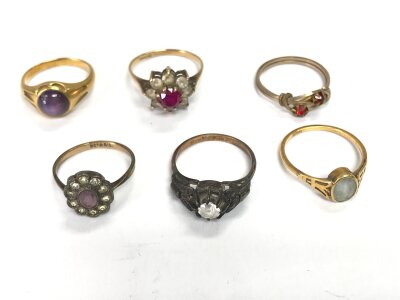 Six assorted gold and silver and other rings set with assorted gems.