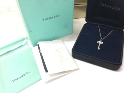 A Tiffany Fluer Dr Lis Platinum and Diamond necklace boxed with Harrods receipt etc. 3.8g