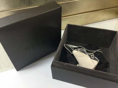 Two silver Gucci dog tags