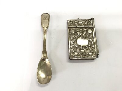 A silver spoon and a note pad with pencil. Spoon is 21.30g