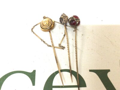Three hat pins including a gold hat pin (3)