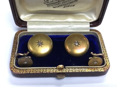 A pair of gold studs.