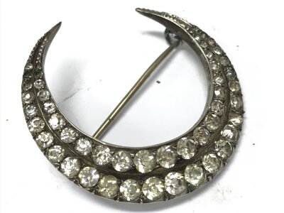 A large antique silver and paste crescent brooch