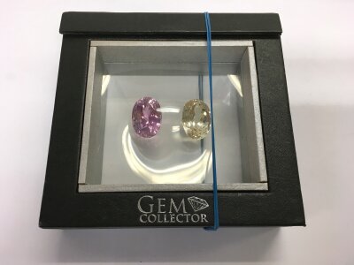 Two cased gemstones comprising a kunzite and one other.