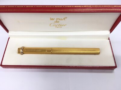 A boxed Cartier pen.