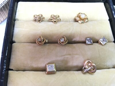 Three pairs of yellow metal earrings and three single earrings.