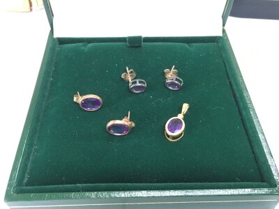 A pair of 9ct gold amethyst earrings and matching pendant plus a further pair of amethyst earrings.