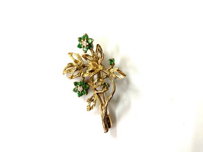 A 9ct gold emerald and white stone brooch.