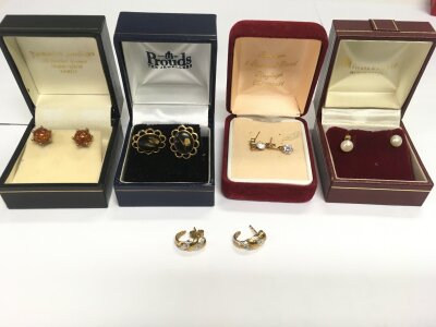 Five pairs of earrings including gold examples.