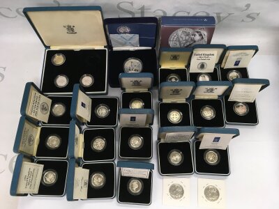 A collection of silver proof one pound coins, a £5 Victorian anniversary commemorative silver proof coin etc.