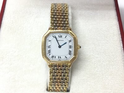 A ladies vintage Cartier Trianon watch with 18ct tri coloured gold strap. White dial and 24mm case. Winds and runs. Comes with box but no papers.