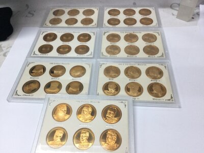 Seven sets of British monarchs rounds in gold plate.