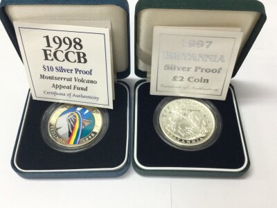 A 1997 silver proof Britannia and a 1998 sterling silver volcano coin.