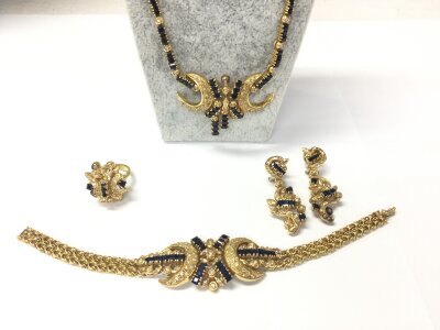 An 18ct gold jewellery suite set with diamonds and sapphires comprising a ring size M earrings bracelet and a necklace which is missing one small part.
119.50g total weight