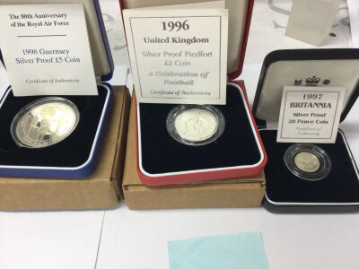 Three silver proof coins including 1998 guernsey 5 pound coin and 1997 20p Britannia