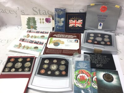 A collection of assorted coin sets and uncirculated coins.