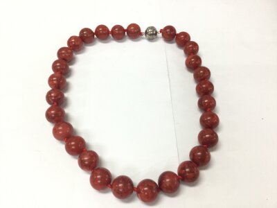 A coral bead necklace with a magnetic clasp.