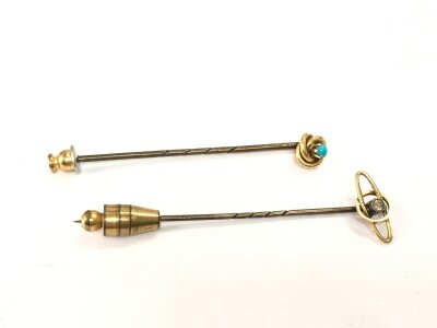 Two 15ct gold stick pins set with stones, approx 3.6g.