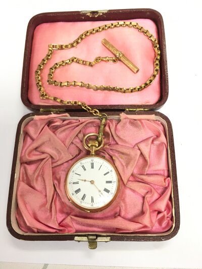 A gold cased open faced fob watch, chain and attached fob.