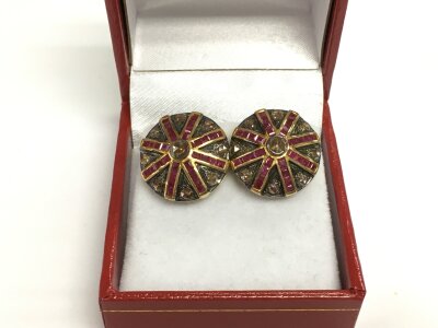 A pair of Art Deco style silver gilt ruby and diamond target ear studs with plastic capped trumpet style butterflies. Step cut rubies approx 2.00ct and rose cut diamonds approx 1.27ct.