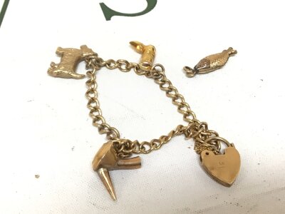 A 9cart gold charm bracelet with a padlock clasp weight 10.8g