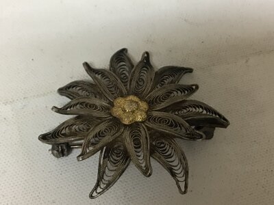 A 14carat gold flower brooch and a filigree brooch