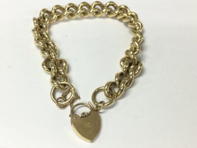 A 9ct gold bracelet with heart shaped padlock.
62.05g
