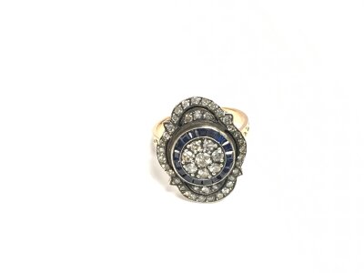 An unhallmarked rose gold Georgian style ring set with RBC diamonds and calibre cut sapphires. Diamonds approx 0.60ct, sapphires approx 0.40ct. Approx 6.5g and approx size N.