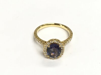 An 18ct gold oval polychroic sapphire and RBC diamond cluster ring. Oval cut sapphire approx 2.53ct and diamonds approx 0.47ct. Approx 4.5g and approx size M-N.