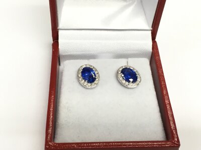 A pair of 18ct white gold oval sapphire and RBC diamond cluster studs. Sapphires approx 2.07ct, diamonds approx 0.36ct. Approx 3g.