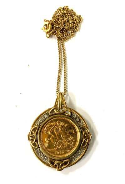 A 2004 Half sovereign with a 9ct gold hale sovereign mount and chain. 11.8g.