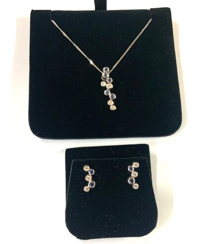 A modern design 18ct white gold sapphire and diamond articulated pendant with a matching paid of stud earrings.