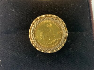 A 1982 1/10th ounce kruggerand set with a 9ct gold ring mount. 7.3g